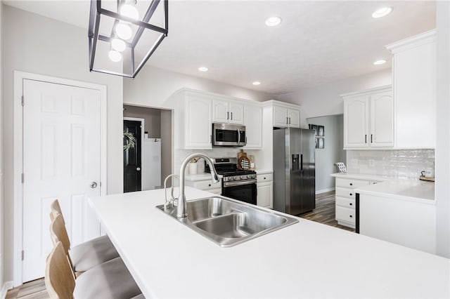 2023 Rainbow Ln, Lima, NY 14485 - kitchen featuring appliances with stainless steel finishes, recessed lighting, white cabinetry, backsplash, and a breakfast bar area
