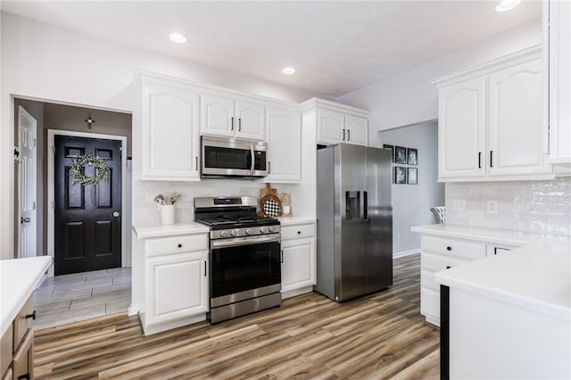 2023 Rainbow Ln, Lima, NY 14485 - kitchen with stainless steel appliances, light wood-style floors, white cabinets, and recessed lighting