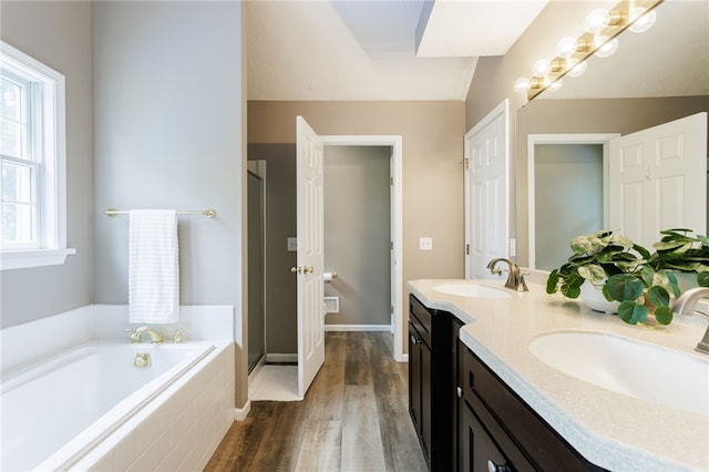 2023 Rainbow Ln, Lima, NY 14485 - full bathroom with double vanity, a shower stall, wood finished floors, and a bath