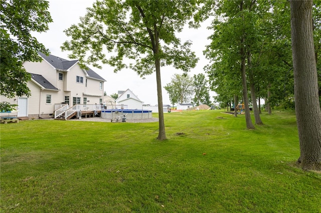 2023 Rainbow Ln, Lima, NY 14485 - view of grassy yard featuring an outdoor pool and a wooden deck