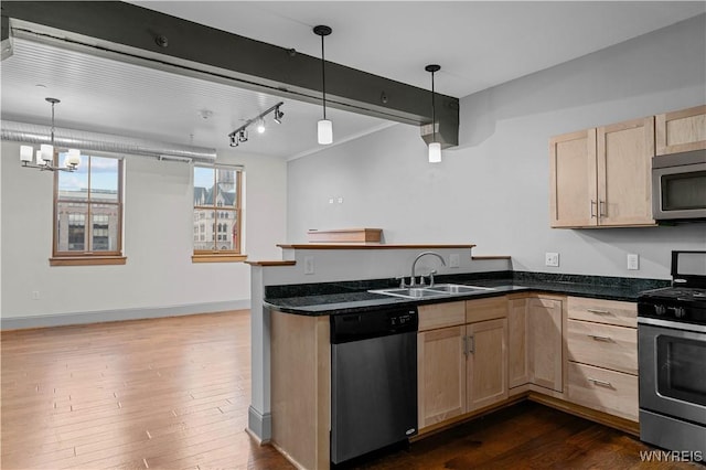 149 Swan St Unit 310, Buffalo, NY 14203 - kitchen with stainless steel appliances, light brown cabinets, a peninsula, dark wood-style floors, and pendant lighting