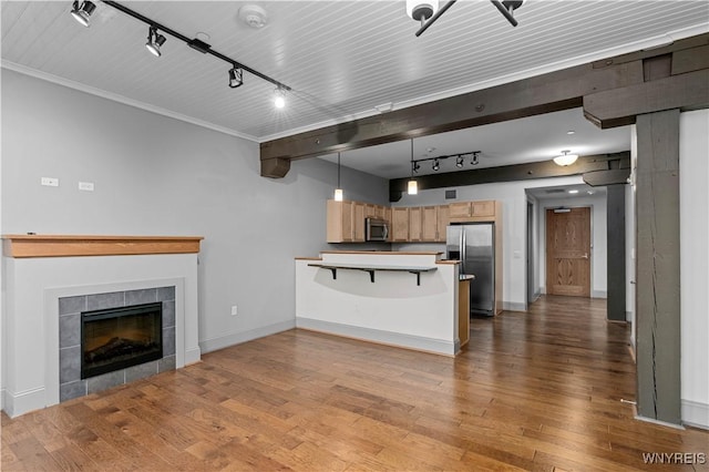 149 Swan St Unit 310, Buffalo, NY 14203 - unfurnished living room featuring rail lighting, wood finished floors, and a fireplace