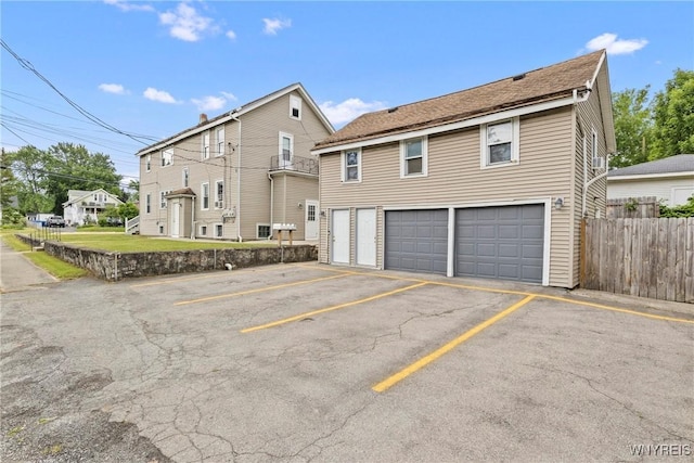 540 Longmeadow Rd, Amherst, NY 14226 - rear view of house featuring uncovered parking and an attached garage