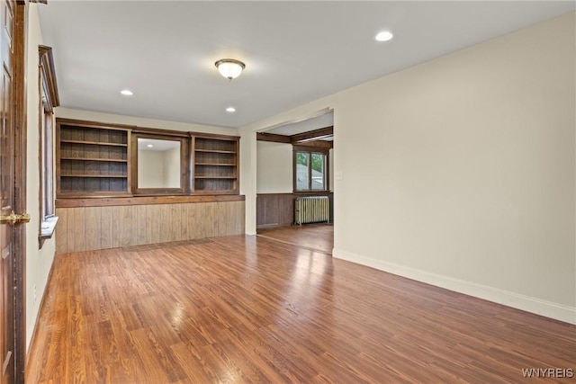 540 Longmeadow Rd, Amherst, NY 14226 - unfurnished room featuring wood finished floors, radiator, and recessed lighting
