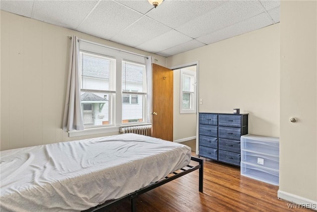 540 Longmeadow Rd, Amherst, NY 14226 - bedroom featuring wood finished floors, a paneled ceiling, and radiator heating unit