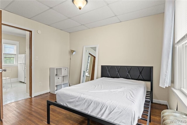 540 Longmeadow Rd, Amherst, NY 14226 - bedroom with wood finished floors, freestanding refrigerator, and a paneled ceiling
