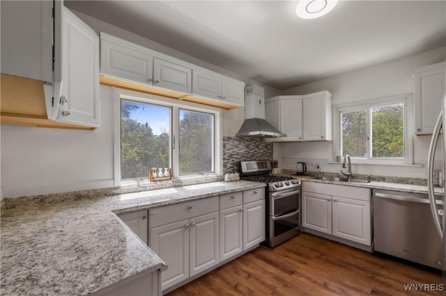 1142 Harlem Rd, Cheektowaga, NY 14227 - kitchen with appliances with stainless steel finishes, wall chimney exhaust hood, white cabinets, and tasteful backsplash