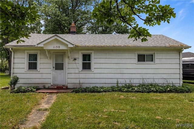 1142 Harlem Rd, Cheektowaga, NY 14227 - view of front facade featuring a front lawn, a chimney, and a shingled roof