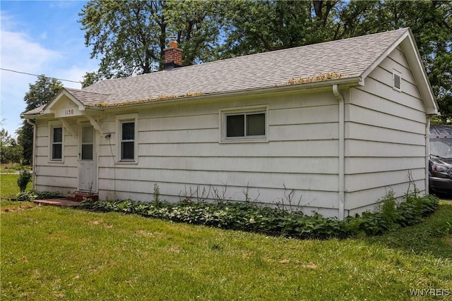 1142 Harlem Rd, Cheektowaga, NY 14227 - view of side of home with a chimney, a lawn, and a shingled roof