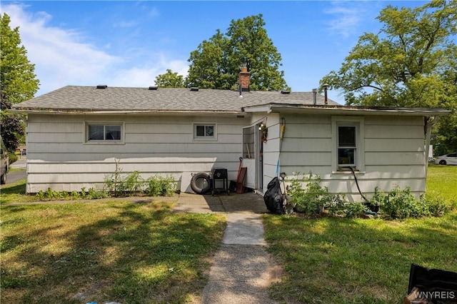 1142 Harlem Rd, Cheektowaga, NY 14227 - back of property with a yard and roof with shingles