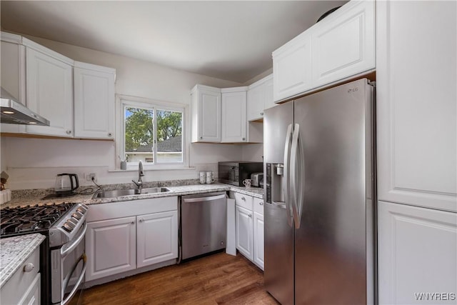 1142 Harlem Rd, Cheektowaga, NY 14227 - kitchen featuring stainless steel appliances, white cabinets, exhaust hood, dark wood-style flooring, and light stone counters