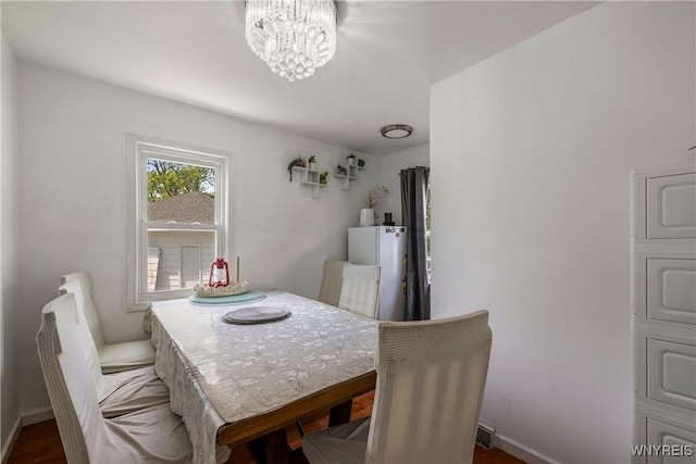 1142 Harlem Rd, Cheektowaga, NY 14227 - dining area with a chandelier and baseboards