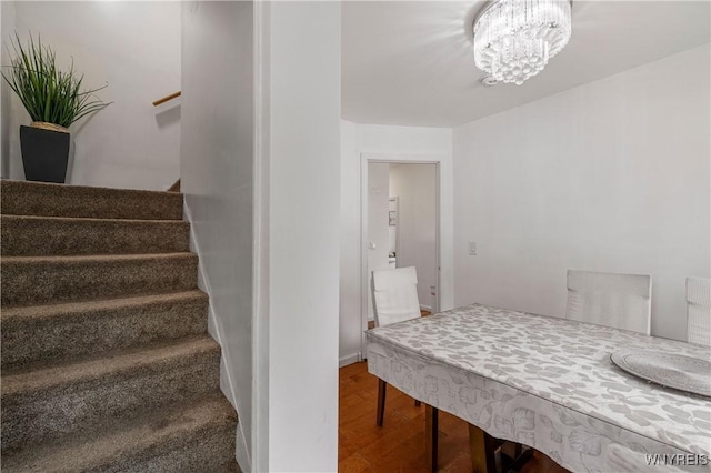 1142 Harlem Rd, Cheektowaga, NY 14227 - staircase with wood finished floors and a chandelier