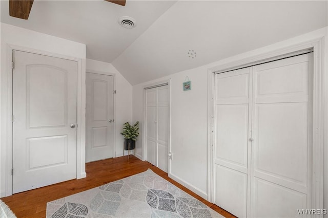 1142 Harlem Rd, Cheektowaga, NY 14227 - unfurnished bedroom with two closets, vaulted ceiling, and wood finished floors