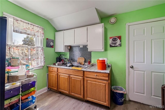 1142 Harlem Rd, Cheektowaga, NY 14227 - kitchen featuring light wood-style floors, lofted ceiling, light countertops, white cabinetry, and brown cabinets