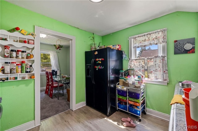 1142 Harlem Rd, Cheektowaga, NY 14227 - kitchen featuring black fridge with ice dispenser, wood finished floors, and vaulted ceiling