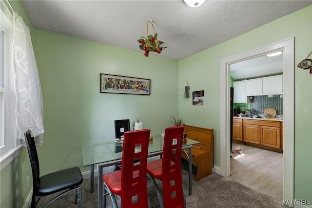 1142 Harlem Rd, Cheektowaga, NY 14227 - dining area with light carpet and a textured ceiling
