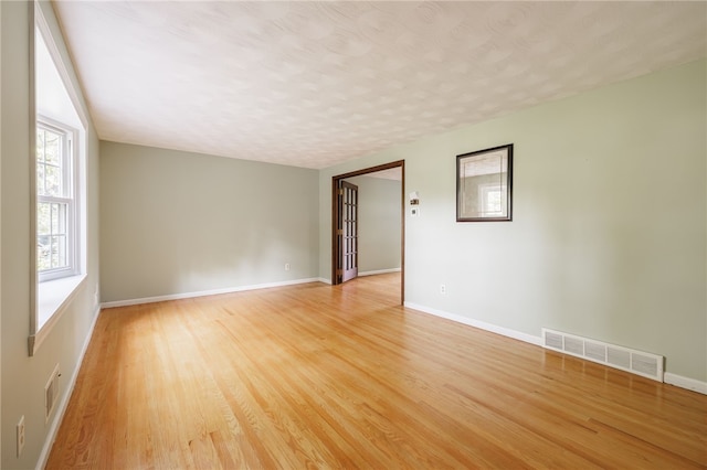 1225 Majestic Way, Webster, NY 14580 - unfurnished room with light wood-style flooring and a textured ceiling