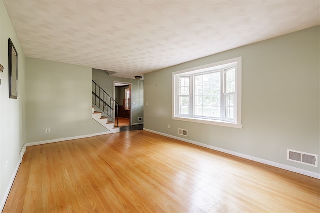 1225 Majestic Way, Webster, NY 14580 - empty room featuring light wood-style flooring and stairway