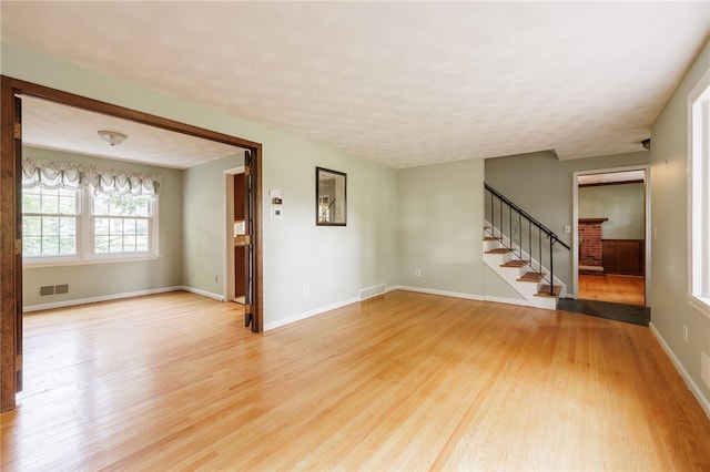 1225 Majestic Way, Webster, NY 14580 - spare room featuring light wood finished floors, stairway, and a textured ceiling