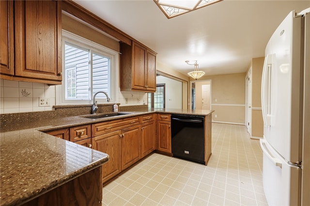 1225 Majestic Way, Webster, NY 14580 - kitchen with freestanding refrigerator, a peninsula, backsplash, and brown cabinetry