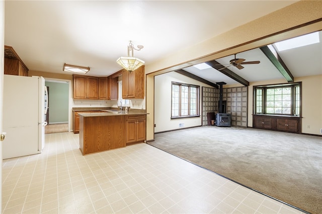 1225 Majestic Way, Webster, NY 14580 - kitchen featuring open floor plan, freestanding refrigerator, a wood stove, and a peninsula