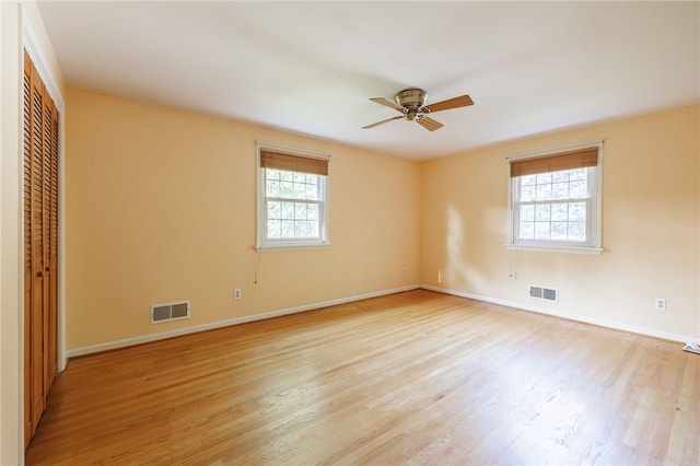 1225 Majestic Way, Webster, NY 14580 - unfurnished bedroom featuring multiple windows, light wood finished floors, a closet, and a ceiling fan