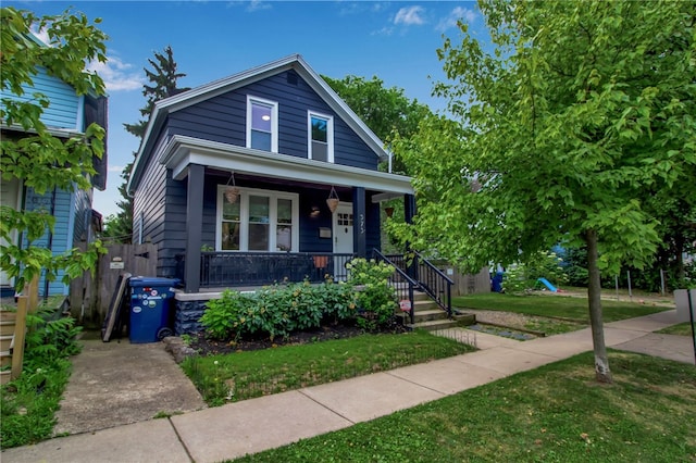 373 Rhode Island St, Buffalo, NY 14213 - view of front of property featuring a porch, a front yard, and a playground