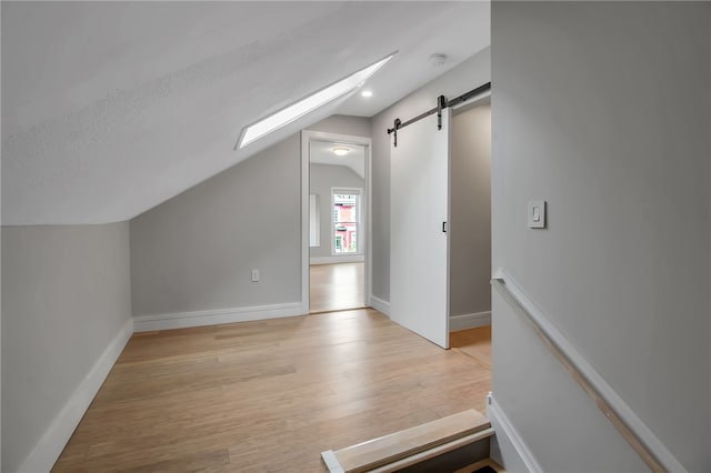 373 Rhode Island St, Buffalo, NY 14213 - bonus room with vaulted ceiling, light wood-style floors, and a barn door