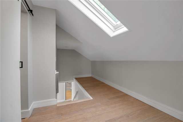 373 Rhode Island St, Buffalo, NY 14213 - additional living space featuring a skylight, vaulted ceiling, and wood finished floors