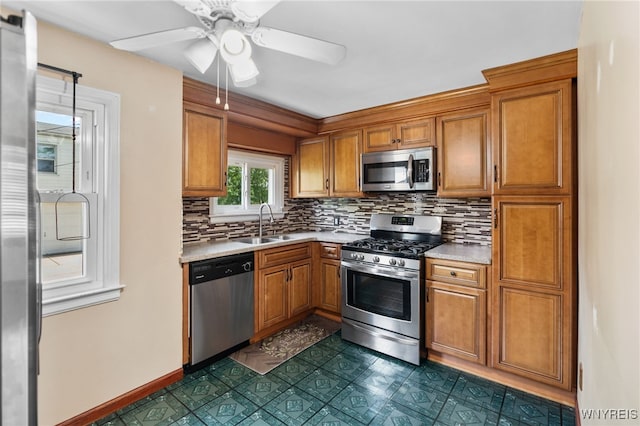 235 Wagner Ave, Cheektowaga, NY 14212 - kitchen featuring stainless steel appliances, brown cabinetry, and light countertops