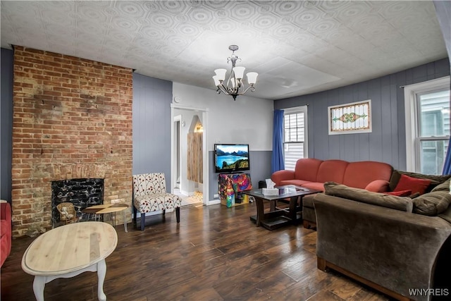 49 Massachusetts Ave, Buffalo, NY 14213 - living room with wood finished floors, a chandelier, and a brick fireplace