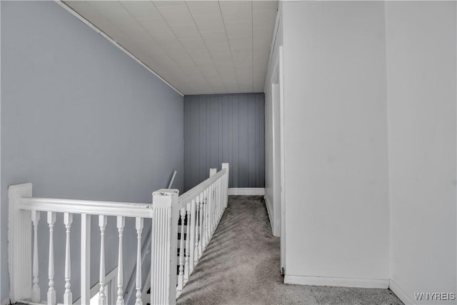 49 Massachusetts Ave, Buffalo, NY 14213 - corridor with an upstairs landing, carpet floors, and wooden walls