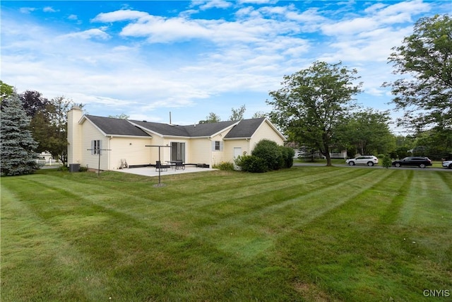 42 Park Ter, Sherrill, NY 13461 - rear view of house with a patio, a lawn, and a chimney