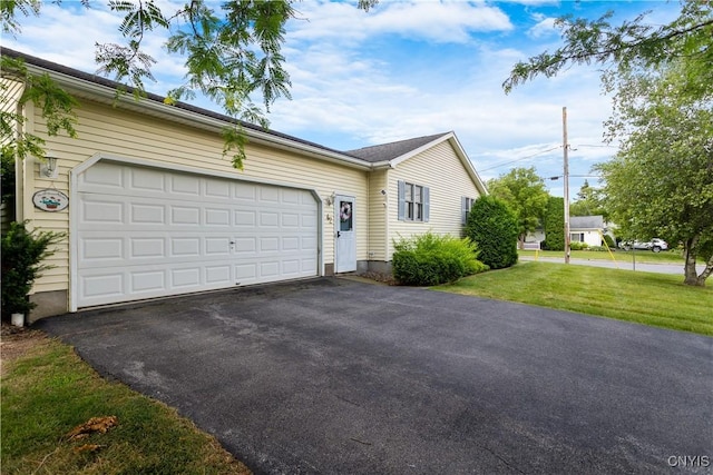 42 Park Ter, Sherrill, NY 13461 - ranch-style home featuring asphalt driveway, an attached garage, and a front lawn