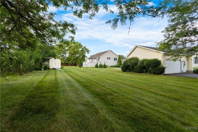 42 Park Ter, Sherrill, NY 13461 - view of green lawn with a storage unit, a garage, and asphalt driveway