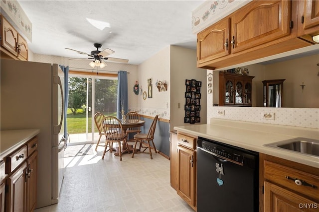 42 Park Ter, Sherrill, NY 13461 - kitchen featuring freestanding refrigerator, dishwasher, light countertops, wallpapered walls, and brown cabinetry