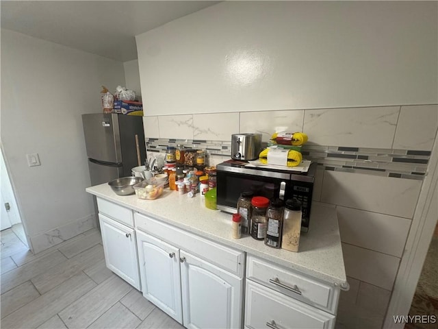 38 Langmeyer Ave, Buffalo, NY 14215 - kitchen with light countertops, white cabinets, appliances with stainless steel finishes, and light wood-type flooring