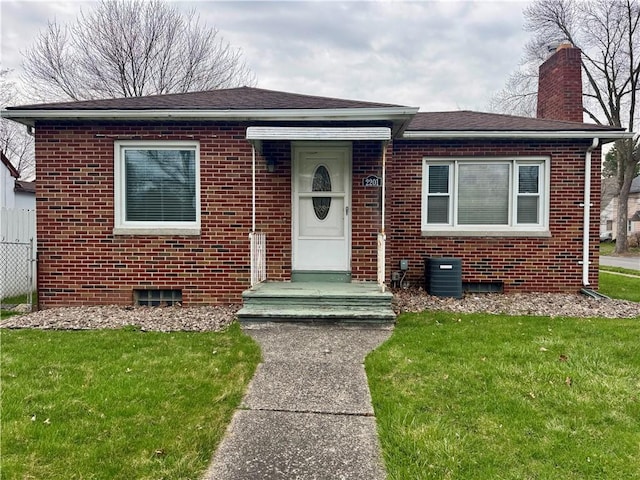 2201 Dewey Ave, Rochester, NY 14615 - view of front facade featuring brick siding, a front lawn, and a chimney