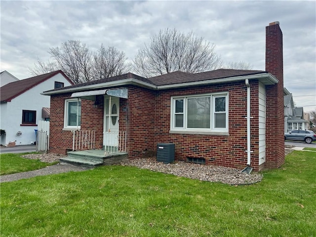 2201 Dewey Ave, Rochester, NY 14615 - bungalow-style house with brick siding, a chimney, and a front lawn