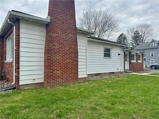 2201 Dewey Ave, Rochester, NY 14615 - view of home's exterior featuring a chimney and a yard