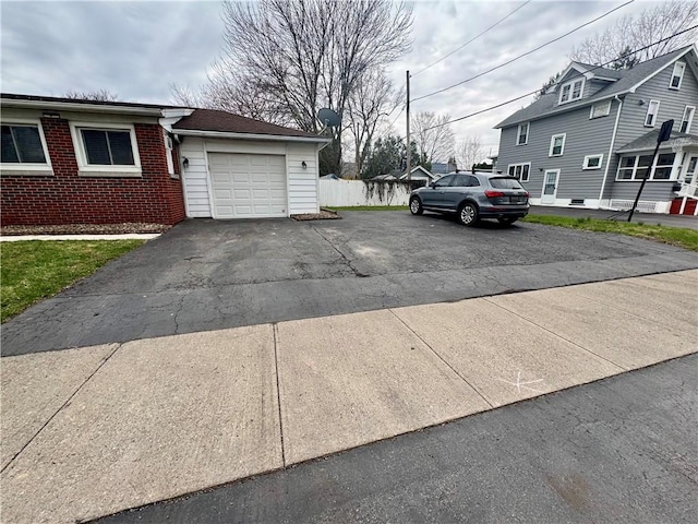 2201 Dewey Ave, Rochester, NY 14615 - view of side of property with asphalt driveway, a garage, and brick siding