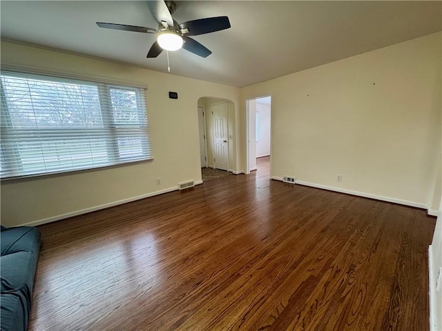 2201 Dewey Ave, Rochester, NY 14615 - unfurnished living room featuring arched walkways, ceiling fan, and dark wood-style floors