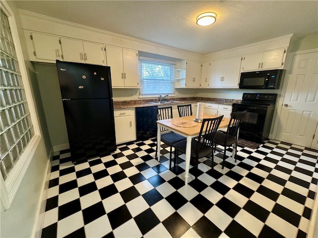 2201 Dewey Ave, Rochester, NY 14615 - kitchen with light floors, black appliances, white cabinets, dark countertops, and crown molding