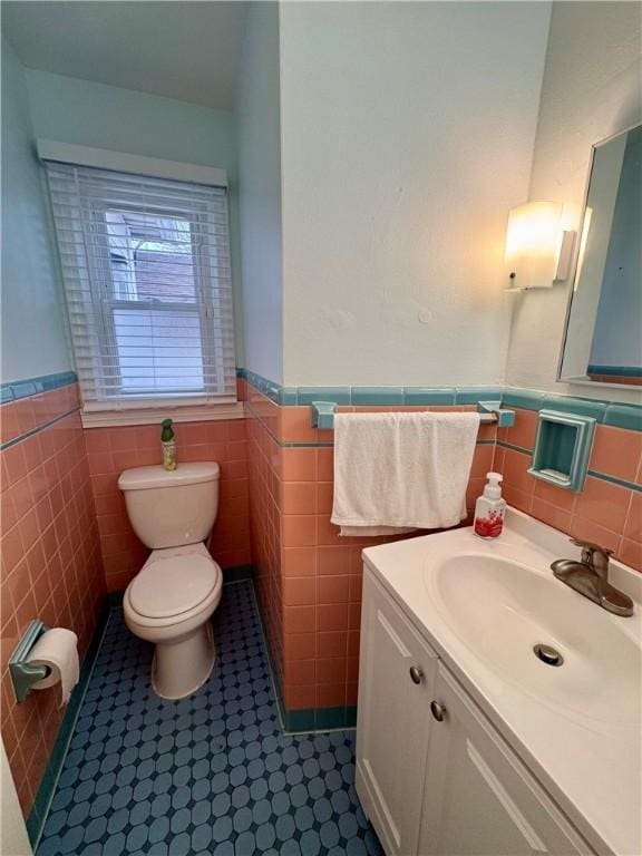 2201 Dewey Ave, Rochester, NY 14615 - bathroom featuring tile walls, vanity, wainscoting, and tile patterned floors