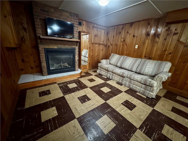 2201 Dewey Ave, Rochester, NY 14615 - living room with tile patterned floors, wood walls, and a brick fireplace