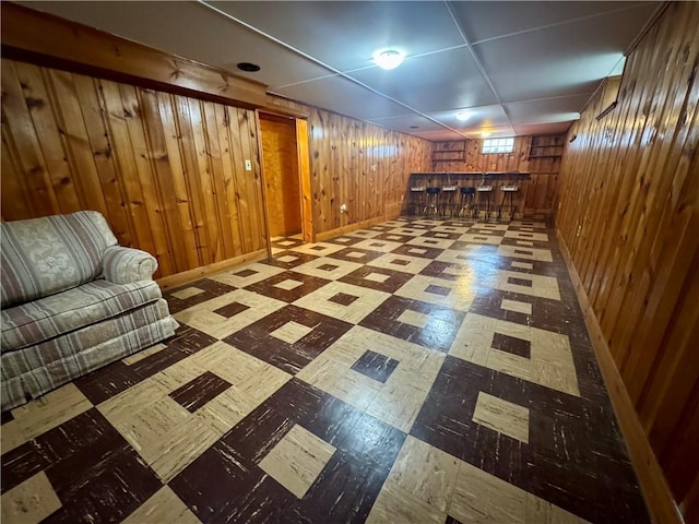 2201 Dewey Ave, Rochester, NY 14615 - basement with tile patterned floors, bar, and wooden walls