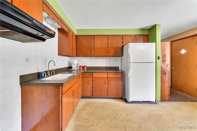 85 Pacific Ave, Lackawanna, NY 14218 - kitchen with freestanding refrigerator, extractor fan, dark countertops, and brown cabinets