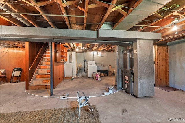 85 Pacific Ave, Lackawanna, NY 14218 - unfinished below grade area with heating unit, stairs, washer / dryer, and wooden walls