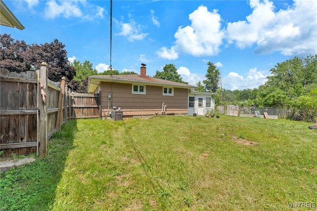 85 Pacific Ave, Lackawanna, NY 14218 - rear view of house featuring a chimney and a fenced backyard